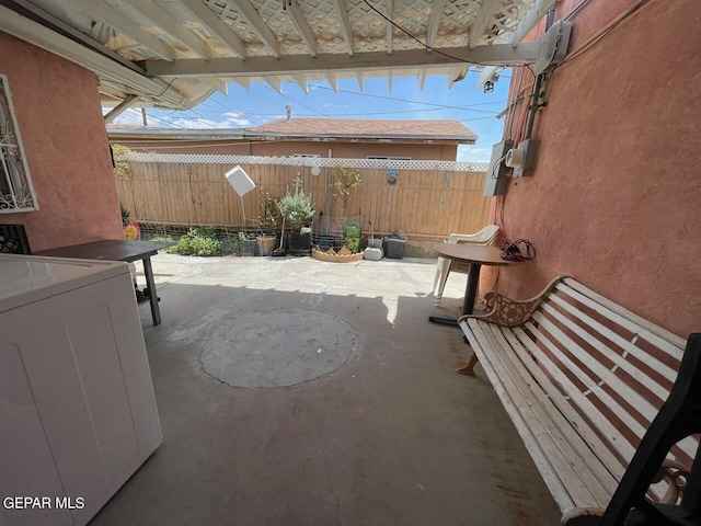 view of patio with washer / clothes dryer and a pergola