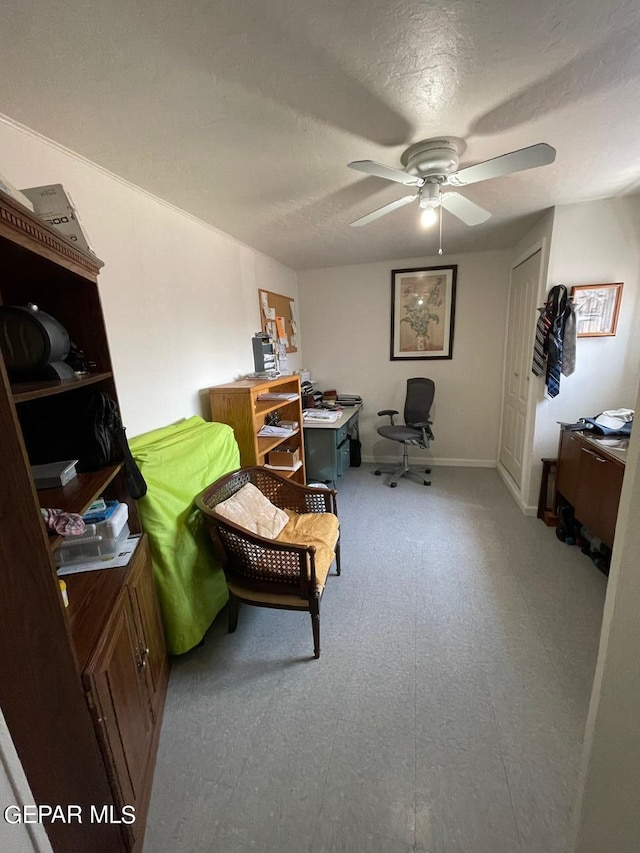 sitting room featuring ceiling fan and tile patterned flooring