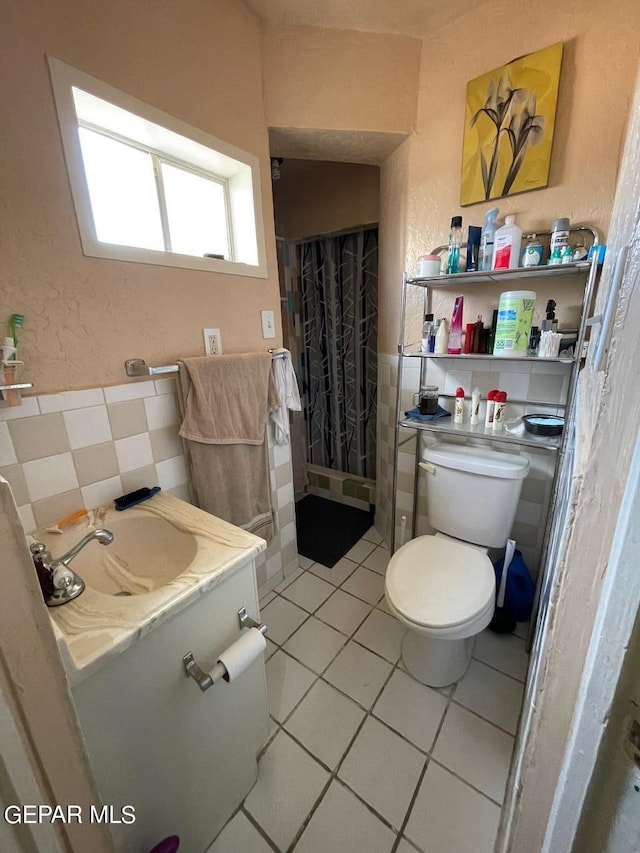 bathroom with vanity, toilet, and tile patterned flooring