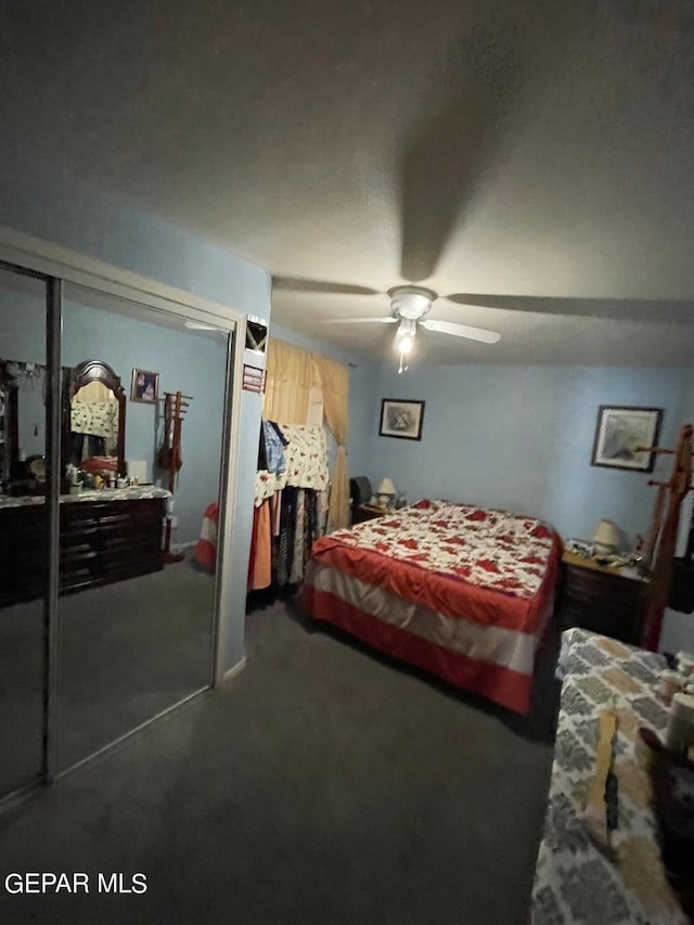 carpeted bedroom with a closet and ceiling fan