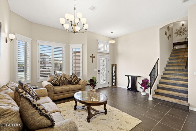 tiled living room with an inviting chandelier