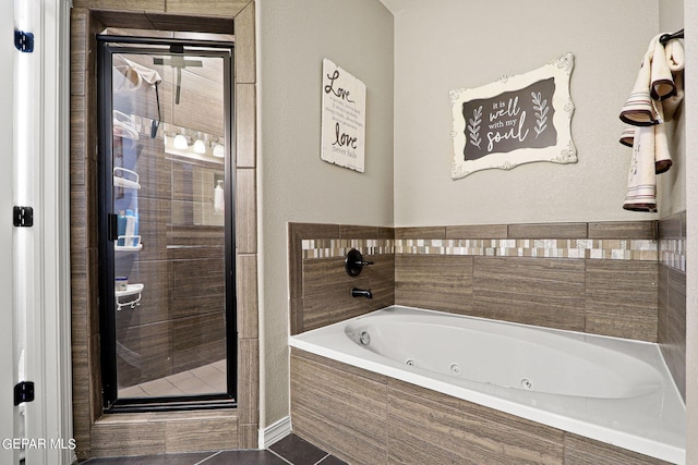 bathroom with tile patterned floors and independent shower and bath