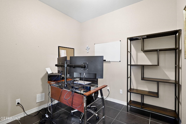 home office featuring dark tile patterned flooring