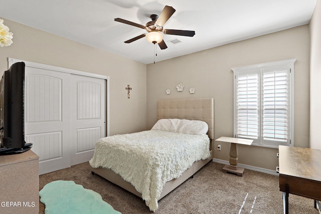 carpeted bedroom featuring ceiling fan and a closet