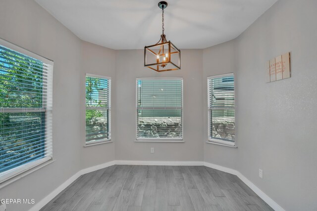 interior space with a notable chandelier and wood-type flooring