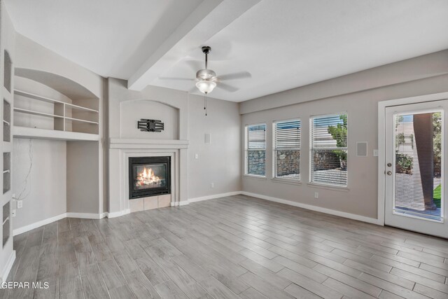 unfurnished living room featuring ceiling fan, beam ceiling, and light hardwood / wood-style flooring