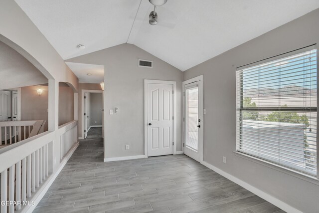 empty room featuring lofted ceiling and wood-type flooring