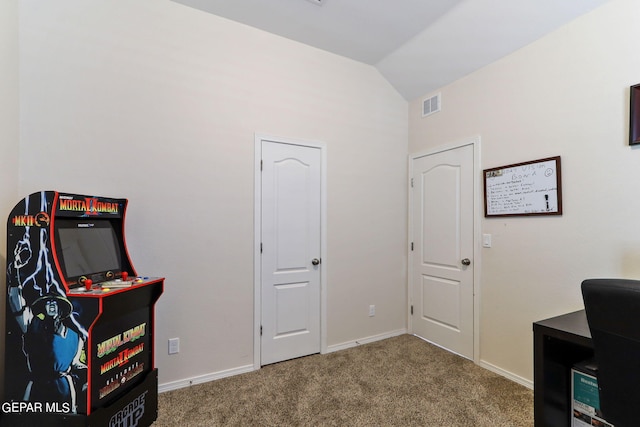 carpeted office space featuring visible vents, baseboards, and lofted ceiling