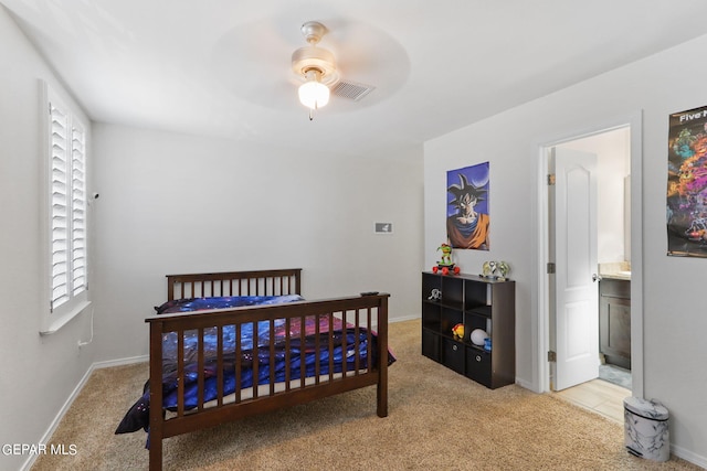 carpeted bedroom with connected bathroom and ceiling fan