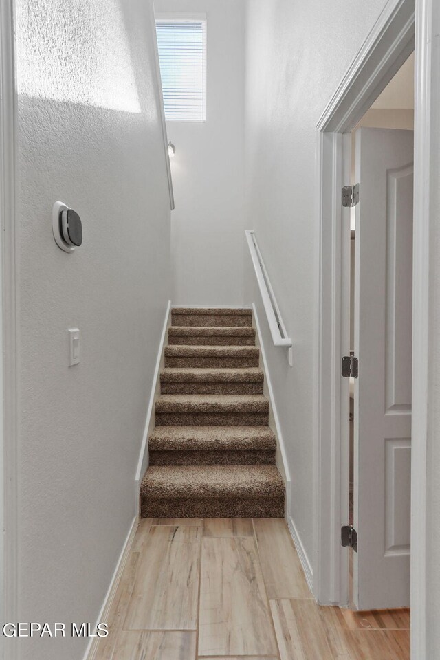 stairway with hardwood / wood-style flooring