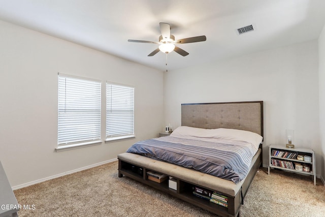 carpeted bedroom with visible vents, baseboards, and ceiling fan