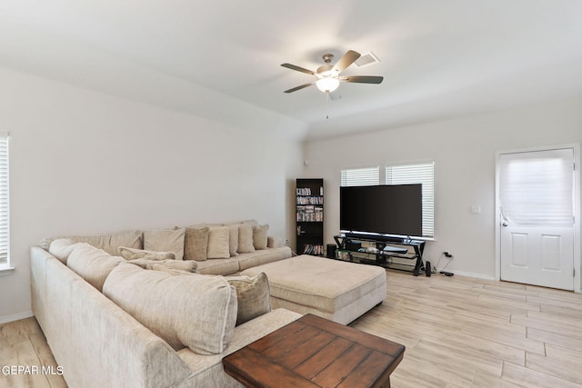 living room featuring ceiling fan and light hardwood / wood-style flooring