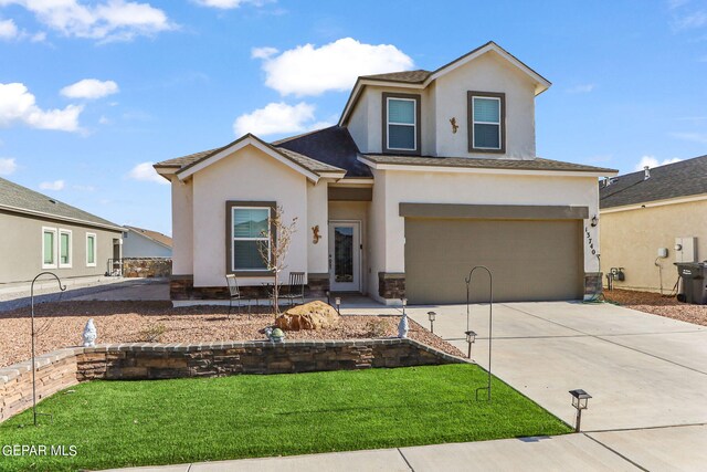 view of front of property with a garage and a front lawn