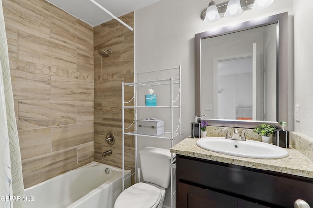 full bathroom featuring tiled shower / bath combo, vanity, and toilet