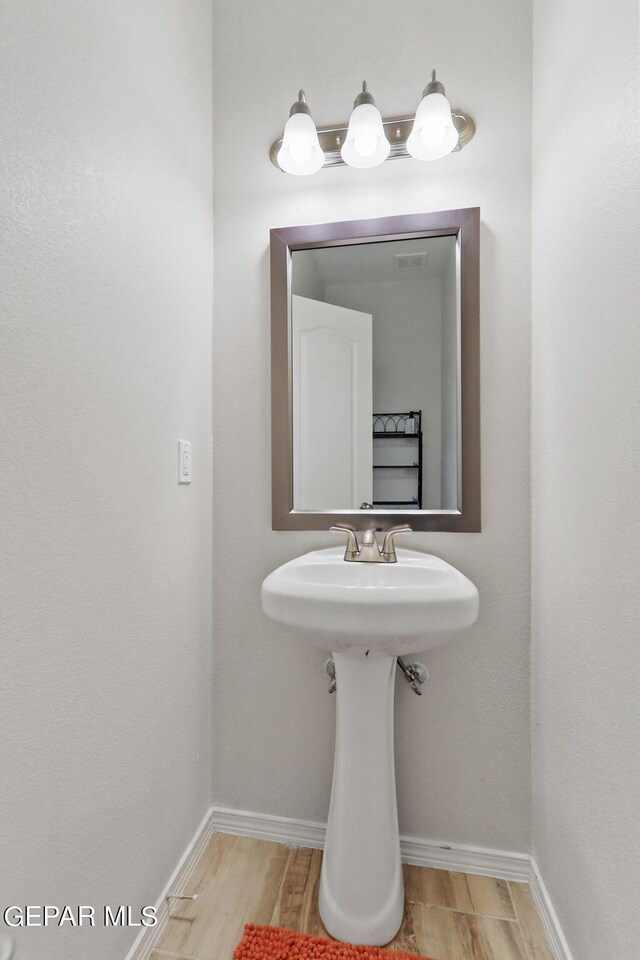 bathroom with wood-type flooring