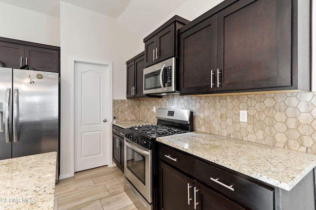 kitchen with dark brown cabinets, wood finish floors, backsplash, and appliances with stainless steel finishes