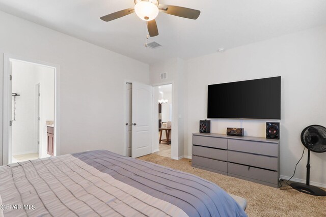 bedroom with light colored carpet, ensuite bathroom, and ceiling fan