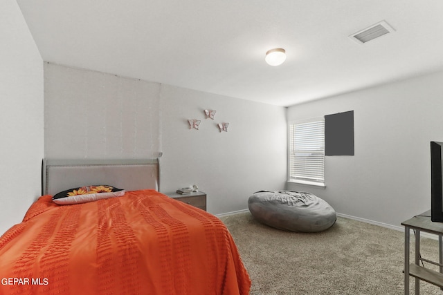 carpeted bedroom featuring baseboards and visible vents