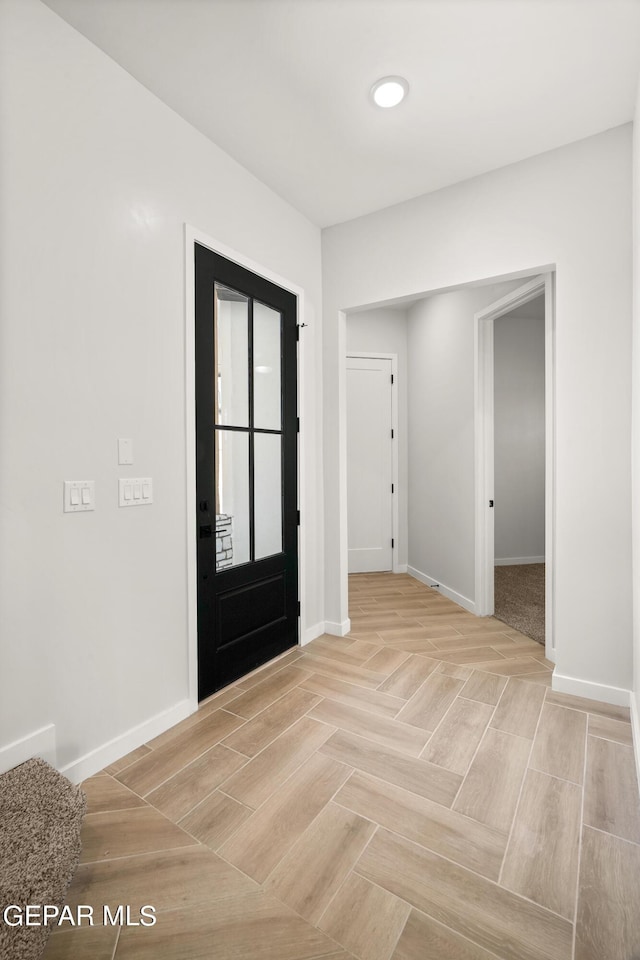 entryway featuring baseboards