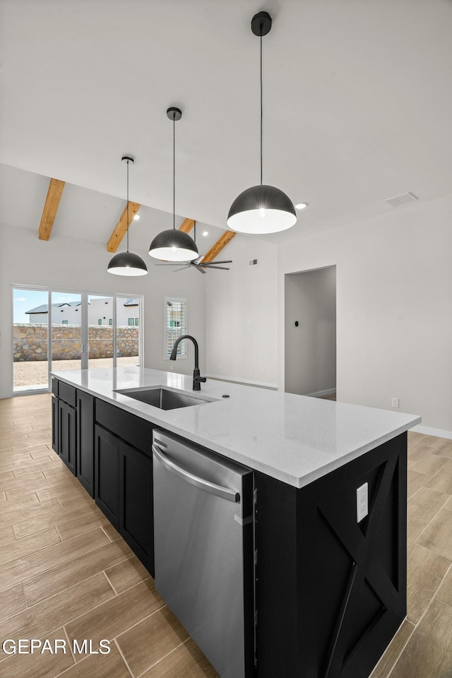 kitchen featuring wood finish floors, a center island with sink, a sink, dark cabinetry, and dishwasher