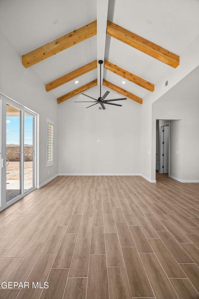 unfurnished living room with wood finish floors, visible vents, and baseboards