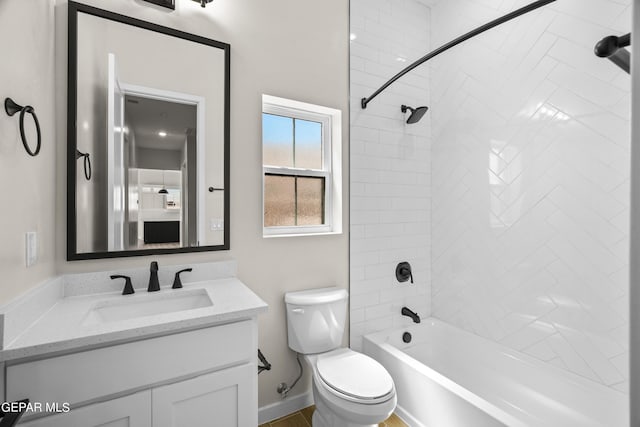 full bathroom with toilet, baseboards,  shower combination, and vanity