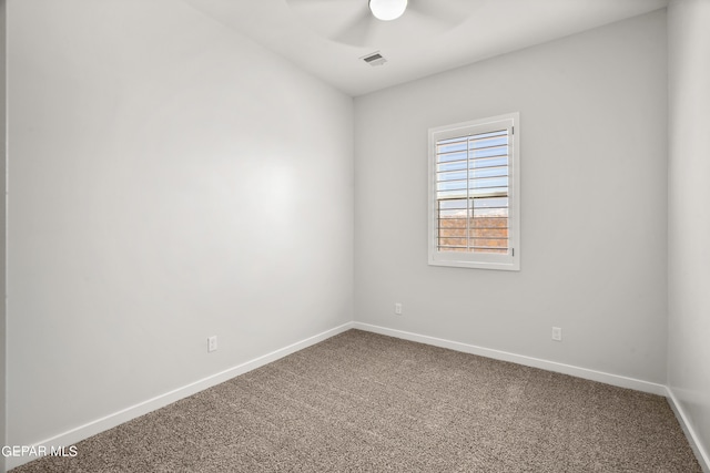 carpeted empty room with a ceiling fan, visible vents, and baseboards