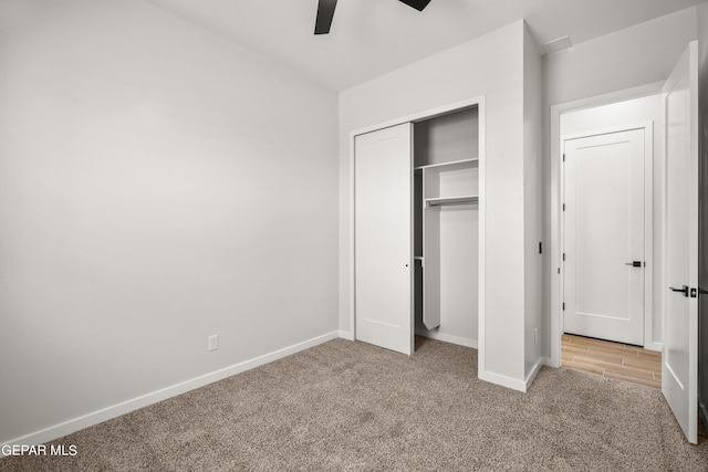 unfurnished bedroom featuring a closet, carpet, a ceiling fan, and baseboards