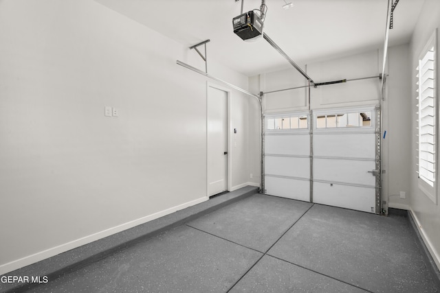 garage with baseboards and a garage door opener