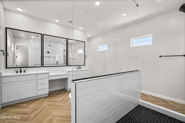 full bathroom featuring visible vents, two vanities, a walk in shower, a sink, and recessed lighting