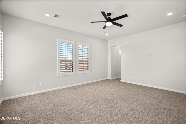 carpeted empty room with visible vents, baseboards, a ceiling fan, and recessed lighting