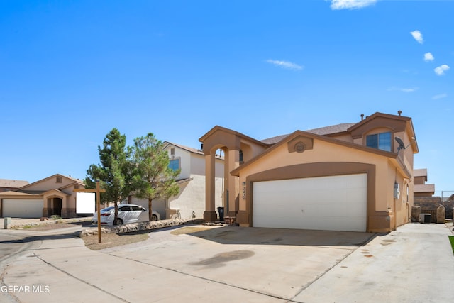 view of front of home featuring central air condition unit and a garage