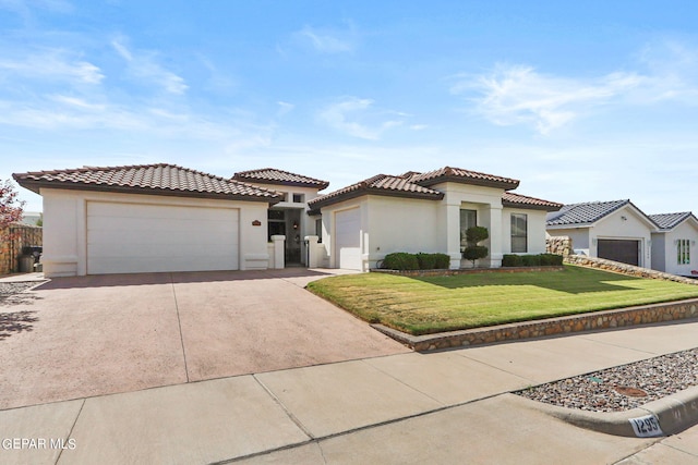 mediterranean / spanish house featuring a front yard and a garage