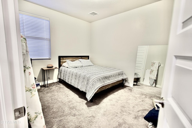 carpeted bedroom with baseboards and visible vents