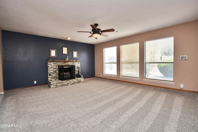 unfurnished living room with a fireplace, carpet, a textured ceiling, and ceiling fan