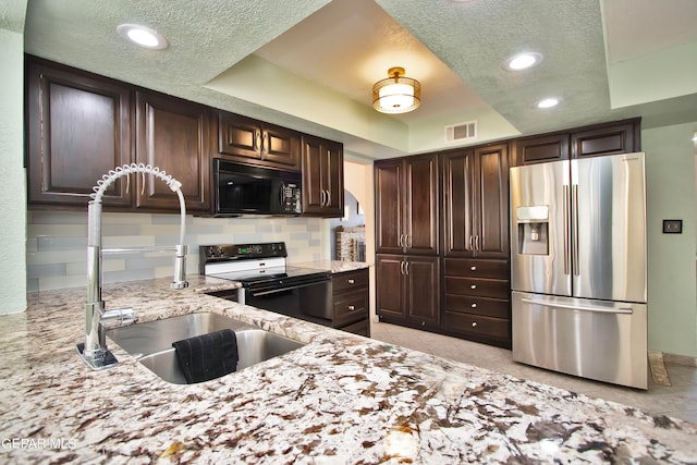 kitchen with stainless steel fridge with ice dispenser, electric range, light tile patterned floors, and tasteful backsplash