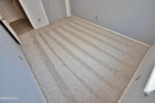 unfurnished bedroom with carpet and a closet