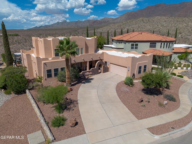 view of front of house featuring a mountain view and a garage