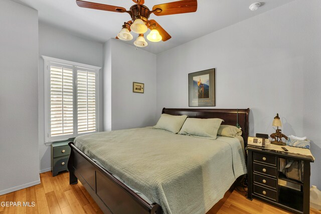 bedroom featuring light wood-type flooring, ceiling fan, and multiple windows