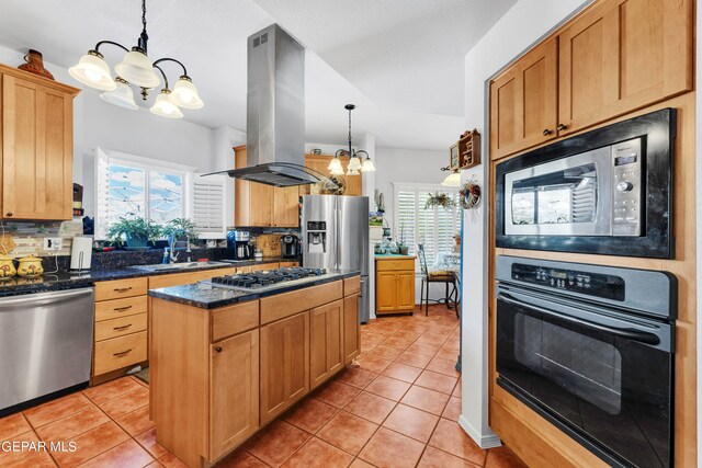 kitchen with decorative backsplash, island exhaust hood, hanging light fixtures, appliances with stainless steel finishes, and an inviting chandelier