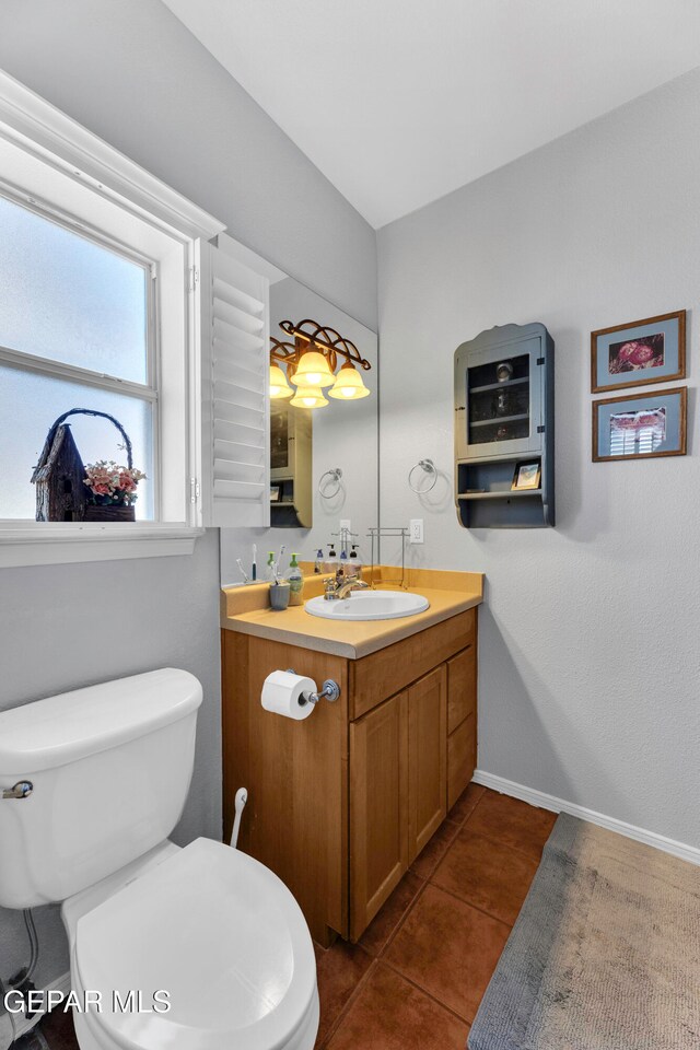 bathroom with tile patterned flooring, vanity, and toilet