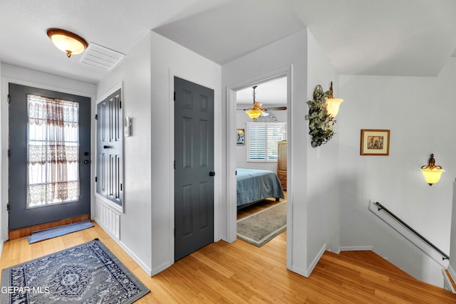 entryway with ceiling fan and light wood-type flooring