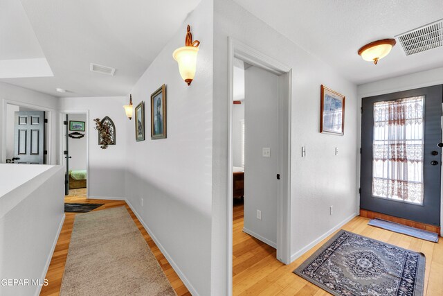 hall with light hardwood / wood-style flooring