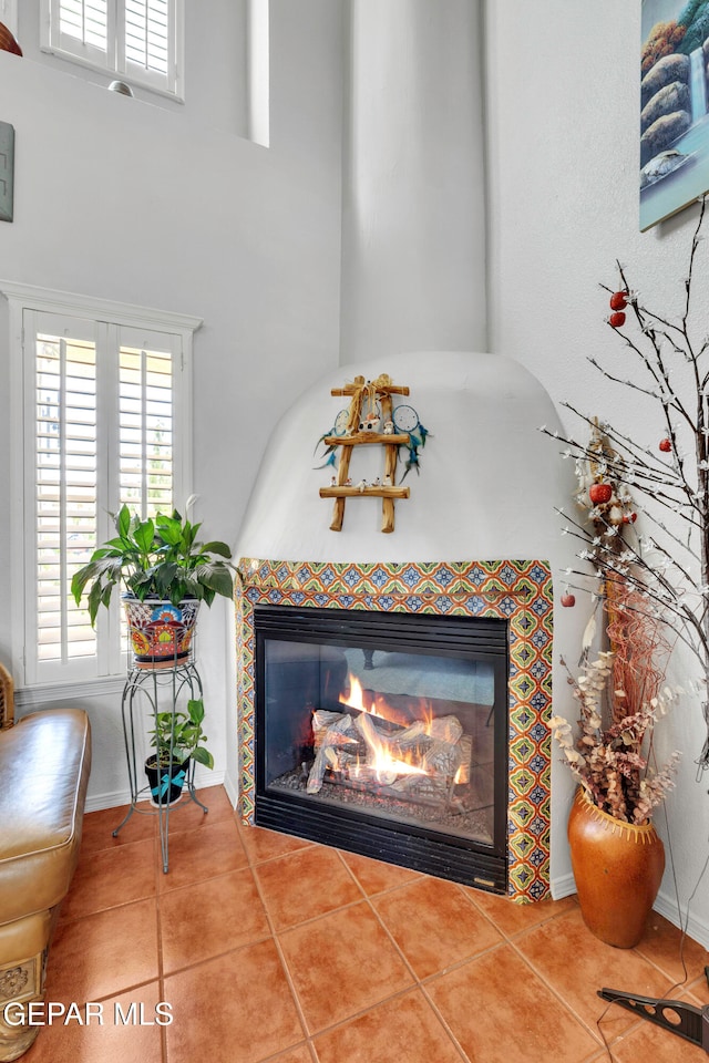 details featuring a tile fireplace and tile patterned flooring