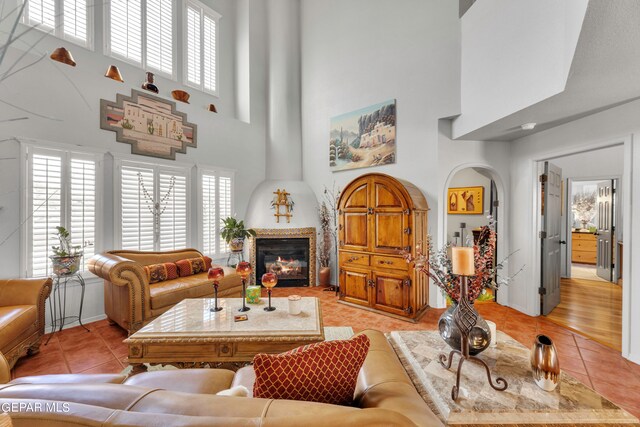 tiled living room with a towering ceiling