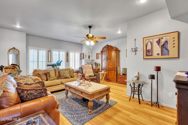 living room featuring ceiling fan and light wood-type flooring