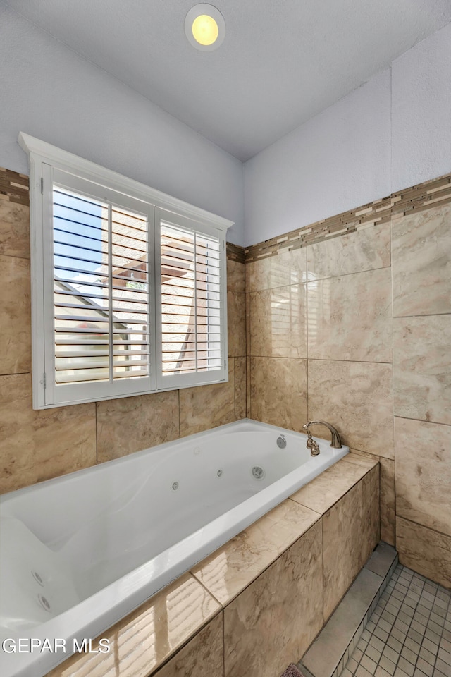 bathroom with tile patterned flooring and tile walls