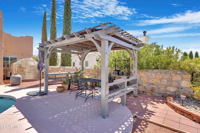 view of patio with a pergola and a storage unit