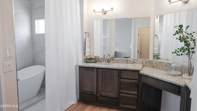 bathroom with hardwood / wood-style floors, a bathtub, and vanity