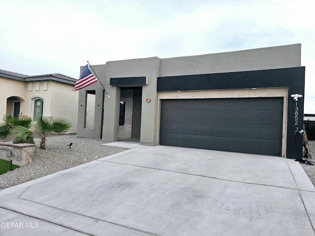 view of front of property with concrete driveway and stucco siding